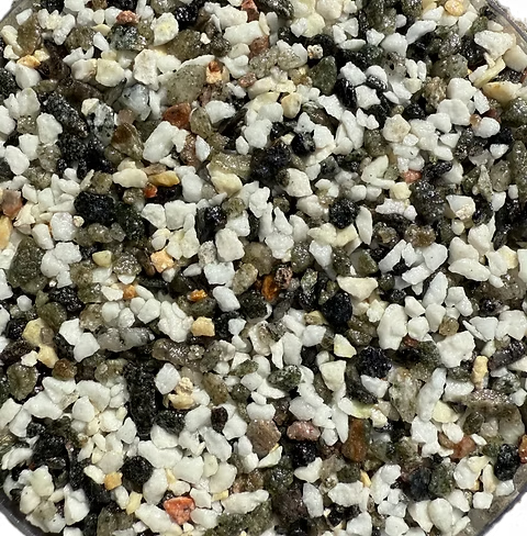 Close-up of a mix of small, irregular gravel pieces in white, black, gray, and brown tones.